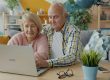 Elderly couple looking at a laptop together