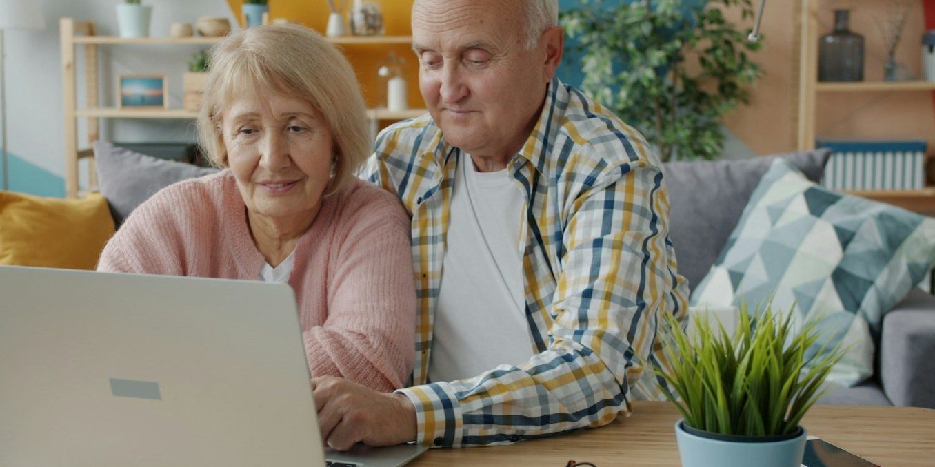 Elderly couple looking at a laptop together