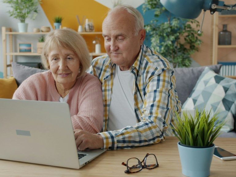 Elderly couple looking at a laptop together
