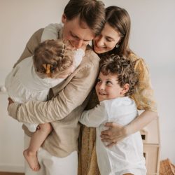 A heartwarming scene of a family hugging indoors, showcasing love and togetherness.