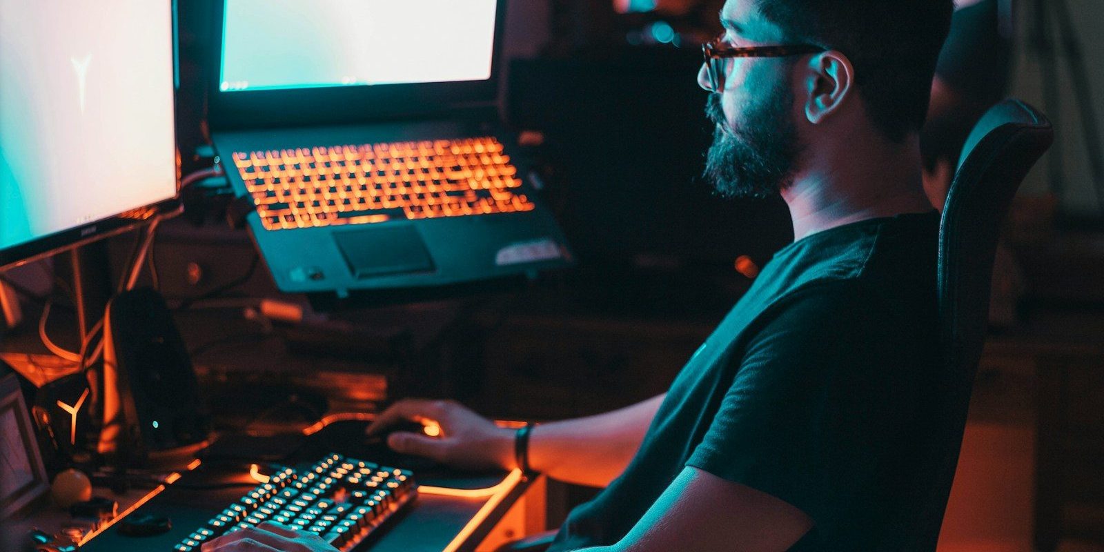 man in blue shirt using computer
