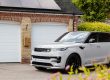 A white range rover parked in front of a house