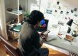 Man working at desk with laptop and phone