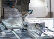 A machine that is cutting a piece of metal