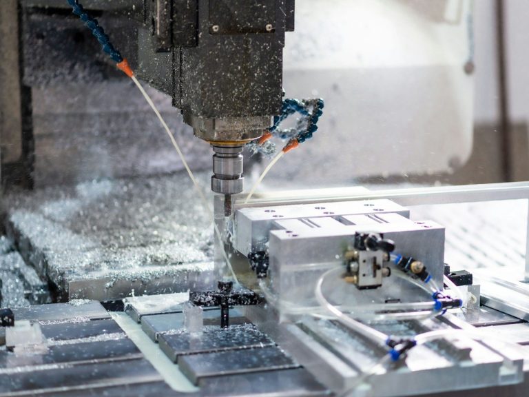 A machine that is cutting a piece of metal